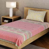 Handwoven Bawan Buti cotton single bedcover in red styled on a wooden bed with tassel details in a contemporary bedroom setting
