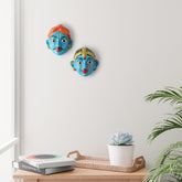 Handcrafted blue Cheriyal couple mask set displayed as wall decor, showcasing traditional Telangana folk art and hand-painted papier-mache craftsmanship