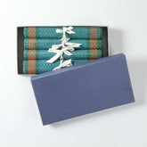 Handmade blue Madhurkathi table runner and placemat set packed in a gift box, featuring natural fibre weaving and colourful border detailing