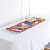 Brick red handwoven cotton runner with geometric zigzag patterns styled on a table as a decorative home accent