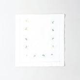 Folded white cotton table runner showcasing delicate daisy embroidery and handcrafted Bengal chikankari detailing