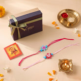 Floral Ribbon Wooden Teddy Bear Kids Rakhi Set of 2 with pink and blue satin ribbon flowers, presented in a gift box, ready for Raksha Bandhan gifting