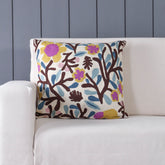 Floral tree hand embroidered crewel cushion cover styled on a sofa adding heritage charm to living room decor