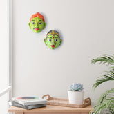 Handcrafted Cheriyal couple mask set displayed as wall decor, showcasing traditional Telangana folk art and hand-painted papier-mache craftsmanship