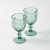 Set of two green diamond wine glasses displayed against a clean background, highlighting handcrafted glasswork