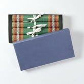 Handmade green Madhurkathi table runner and placemat set packed in a gift box, featuring natural fibre weaving and colourful border detailing