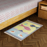 Grey handwoven cotton dhurrie with duck and fish motifs styled in a living space as a decorative floor accent