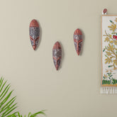 Hand carved African wooden mask displayed as wall hanging decor, featuring decorative metal detailing and traditional African tribal art craftsmanship