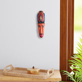 Hand-carved Hanuman Gomira wooden wall mask displayed as living room wall decor, showcasing vibrant folk art and traditional Indian craftsmanship