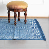 Diamond Trellis block printed indigo cotton dhurrie rug styled in a living room, showcasing handcrafted patterns and contemporary home decor