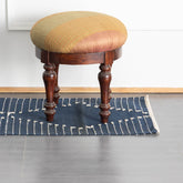 Indigo stripe handwoven cotton dhurrie rug styled in an entryway adding warmth texture and handcrafted charm to the space