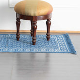 Indigo trellis block printed cotton dhurrie rug styled in an entryway adding handcrafted texture and timeless appeal to the space