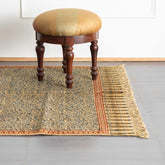 Hand block printed Kalamkari mustard cotton dhurrie rug styled in a living room adding warmth and artisanal charm to home interiors