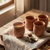 Curved terracotta kulhad chai cups served with hot tea for an authentic chai experience