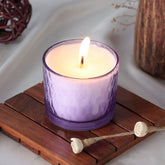 Lavender scented soy candle glowing softly in a home setting creating a relaxing atmosphere