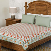 Marigold buti block printed king bedcover styled on a bed with coordinated cushions in a bright and inviting bedroom setting
