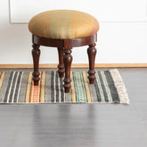 Multicolor geometric stripe block printed cotton dhurrie rug styled in an entryway, adding vibrant handcrafted character to the space