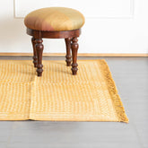 Mustard handloom cotton dhurrie with abstract block print patterns styled in a living room as a vibrant floor accent
