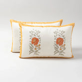 Set of 2 Chanderi lumbar cushion covers featuring orange marigold buta block prints and hand embroidery on an off-white base