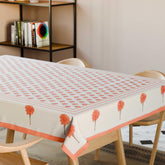 Orange marigold buti block printed cotton table cloth styled on a dining table with coordinated tableware and festive decor
