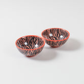 Zebra Pattern ceramic bowl set of 2 featuring a vibrant orange base with handpainted black zebra-inspired artwork, ideal as snack bowls, small serving bowls, and decorative tableware
