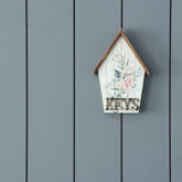 Handmade bamboo decoupage wall key holder with pink floral artwork mounted on a wall, designed to organise home and car keys stylishly
