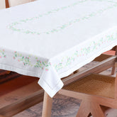 Pink blossoms embroidered cutwork table cloth styled on a dining table for elegant dining table decor and entertaining