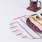 Round cotton placemats with red and green stripe block print patterns styled on a dining table, creating a vibrant table setting and dining table décor