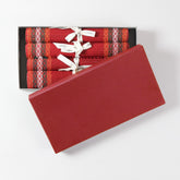 Handmade red Madurkathi table runner and placemat set packed in a gift box, featuring natural fibre weaving and colourful border detailing