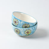 Handmade Sunflower ceramic portion bowls arranged in a stacked display on a plain background, showcasing vibrant floral artwork and glossy finish