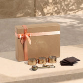 Premium tea gift set with tea blends, brass spoon tea brewer, and handcrafted wooden coasters, ideal for festive gifting and special occasions