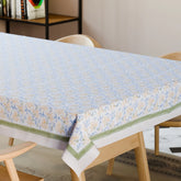 Yellow lily hand block printed cotton tablecloth styled on a dining table with coordinated tableware and floral decor