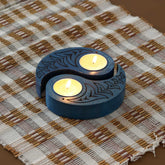 Hand-carved wooden Ying-Yang bird T-light holders set of 2 in blue, displayed with lit tea lights on a woven table line, ideal for handmade decor and Diwali decor