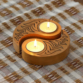 and carved wooden Ying Yang bird T-light holders set of 2 in yellow, displayed with lit tea lights on a woven mat, ideal for handmade decor and Diwali decor