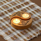 Hand carved wooden Ying Yang floral T-light holders set of 2 in yellow, displayed with lit tea lights on a woven mat, ideal for handmade decor and Diwali decor