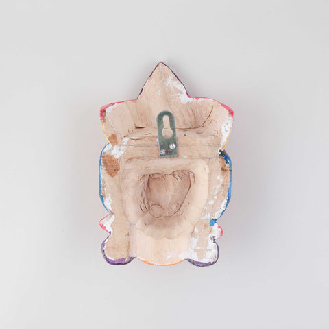 Back view of a handmade wooden Gomira wall mask showing the carved wood construction and hanging arrangement