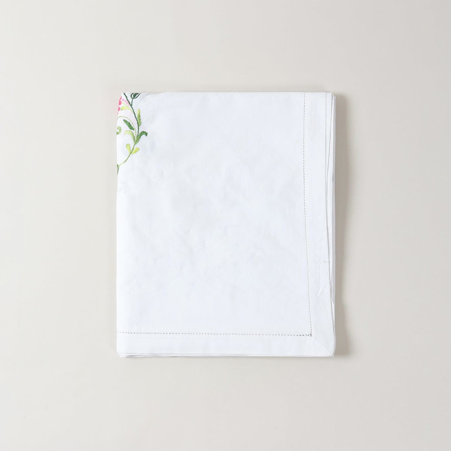 Folded Bengal chikankari embroidered table cloth with Rangoon creeper floral motifs