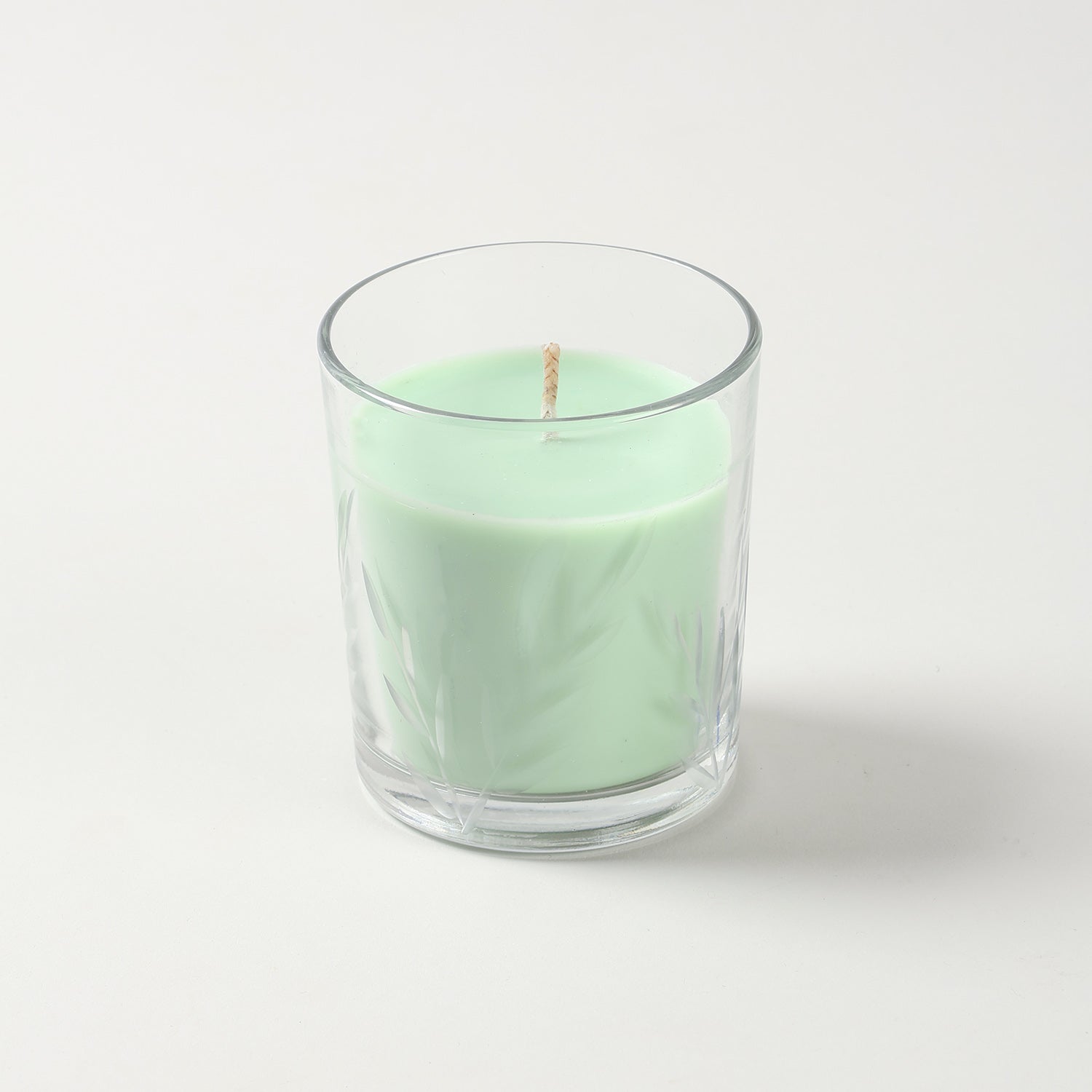 Green apple scented soy candle in decorative green glass jar