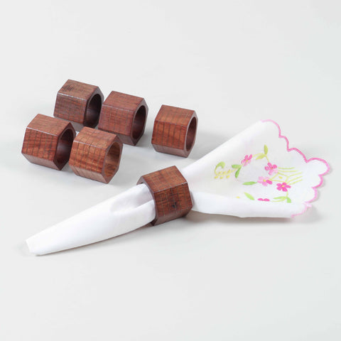 Hexagon wooden napkin rings with striped brass inlay for modern dining table settings