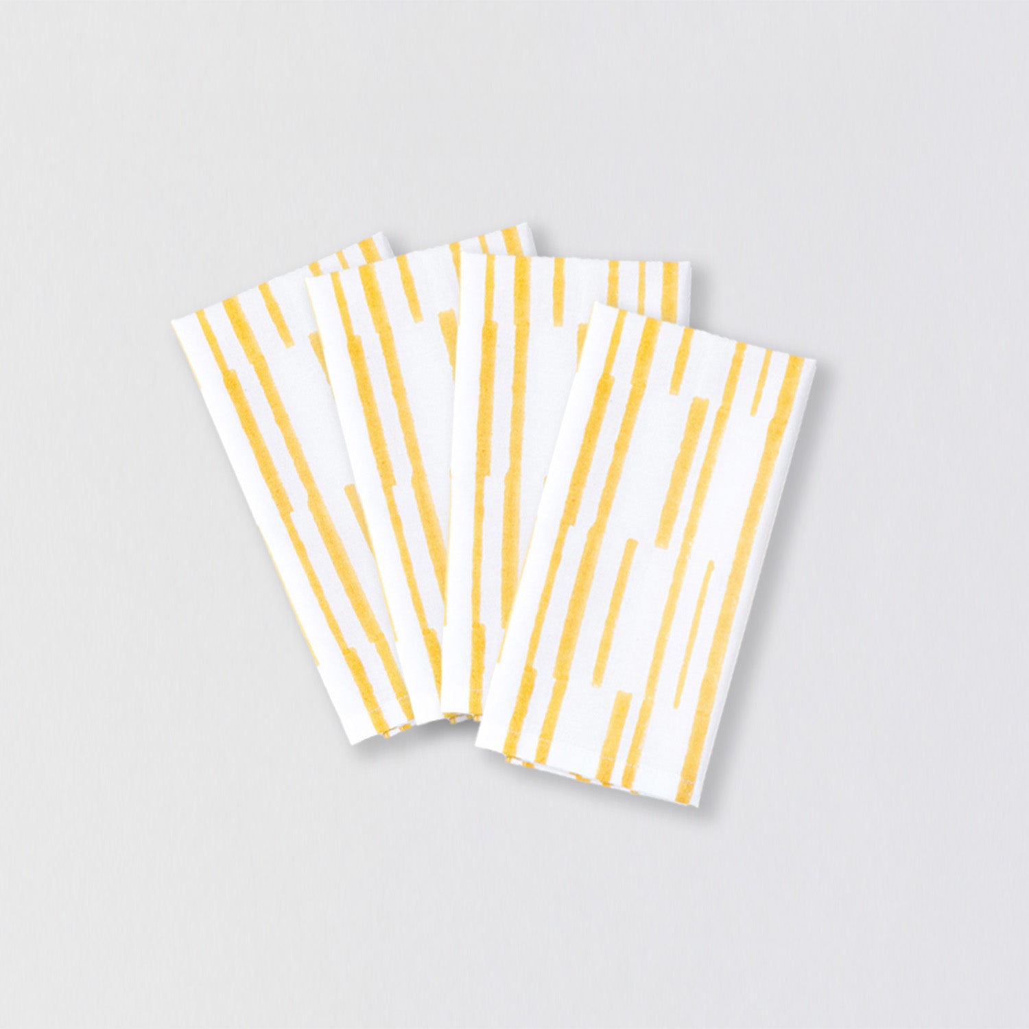 Set of four hand block-printed cotton table napkins with a yellow linear pattern for family dining