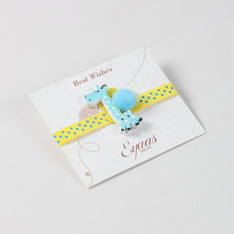 Angled view of the handmade sky blue giraffe Wooden Kids Rakhi attached to an Best Wishes greeting card.