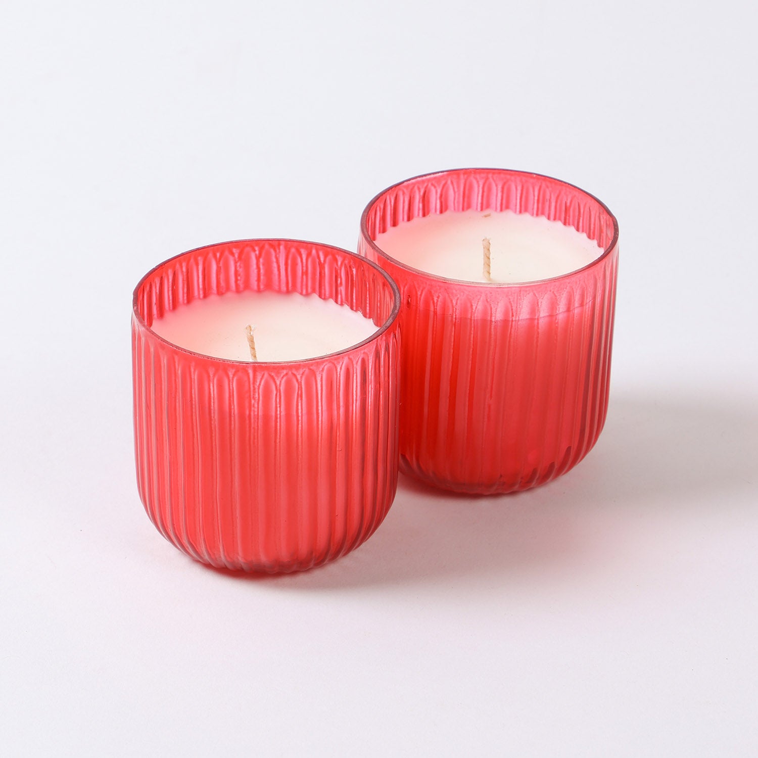 Set of two red scented glass candles with soy wax and warm apple cinnamon fragrance