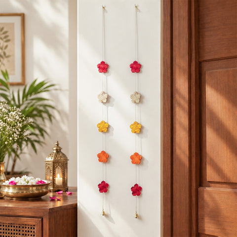 Multicoloured bamboo flower hangings, festive room decor styled beside a doorway
