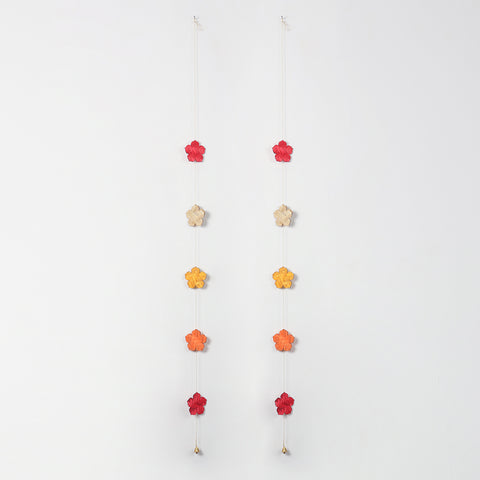 Full view of two handcrafted bamboo flower latkans in festive colours