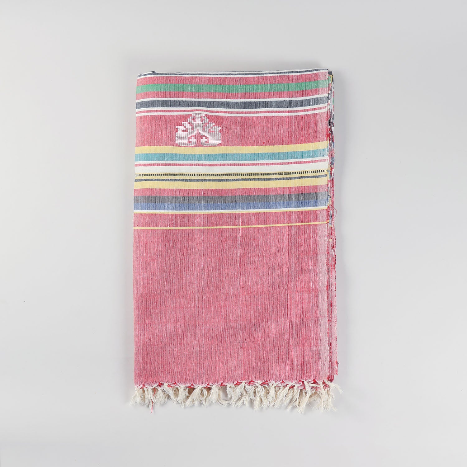 Folded red cotton single bedcover featuring handwoven Bawan Buti elephant motifs, colourful woven stripes, and white fringe tassels
