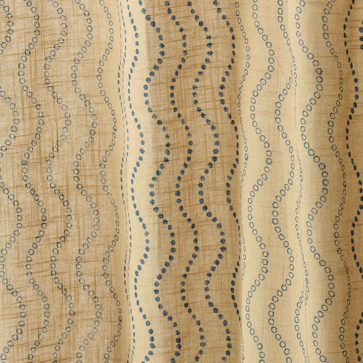 Close-up of beige cotton slub curtain fabric with a handcrafted Blue Wave block print.