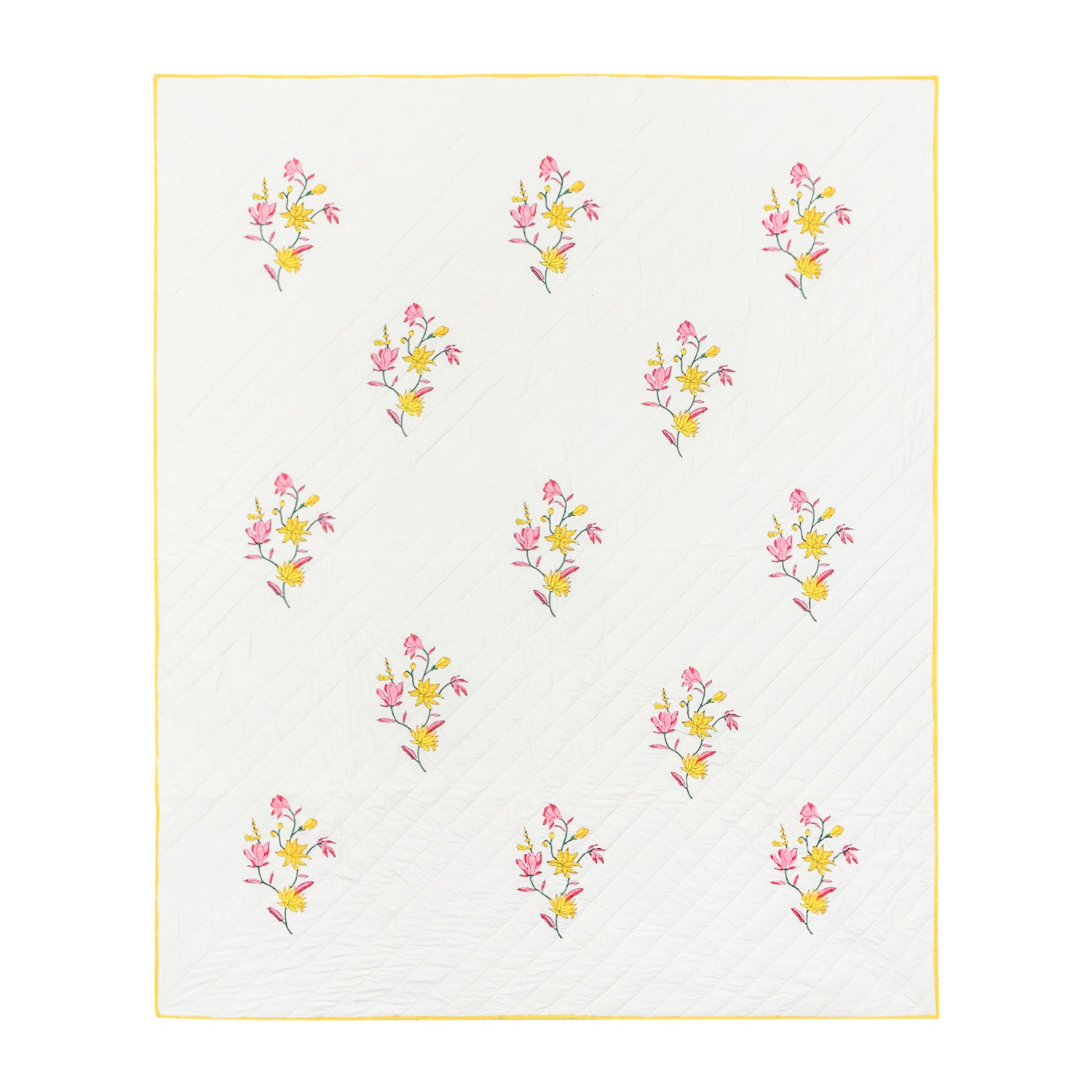 Full view of a king size hand block printed cotton quilted bedspread with pink and yellow floral motifs on a sage green base