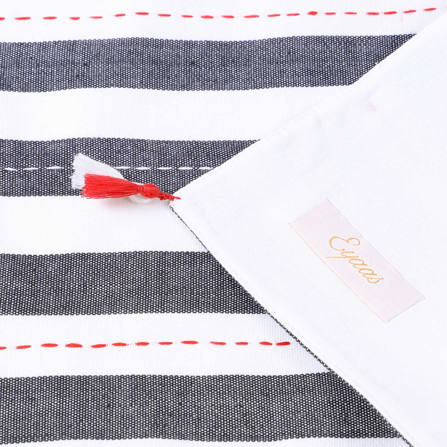 Detailed back and front view of a black and white hand-woven cotton table runner