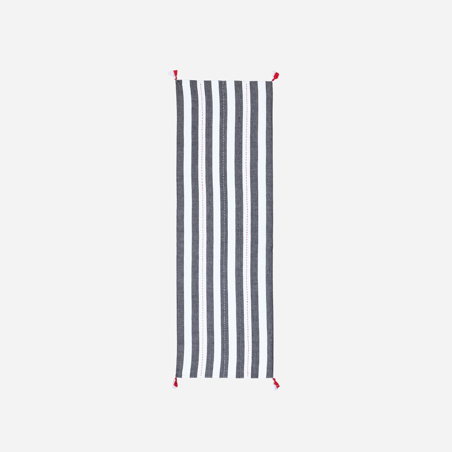 Full-length handwoven cotton table runner featuring black and white stripe patterns with tassels displayed on a plain background