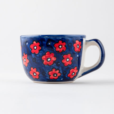 Handpainted floral ceramic mug featuring blue and red motifs, ideal for coffee, tea, and everyday tableware use